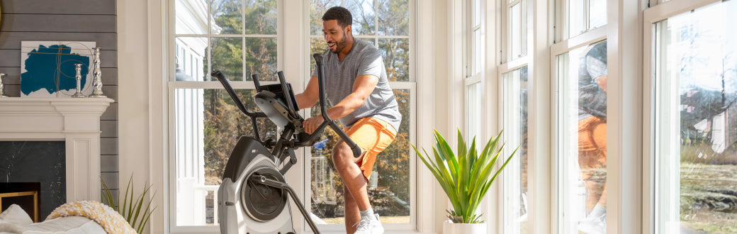 man using a bowflex maxtrainer