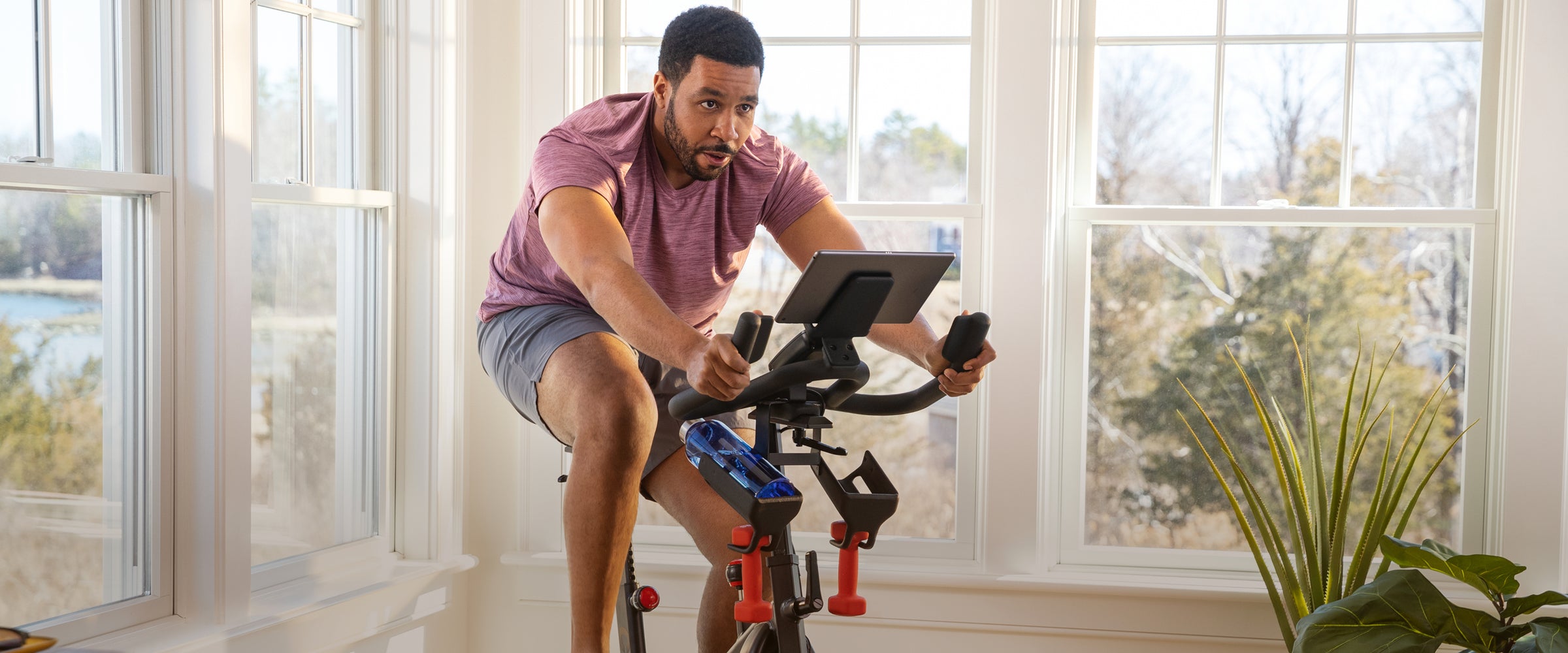 Man riding the BowFlex C6 Bike in his living room.