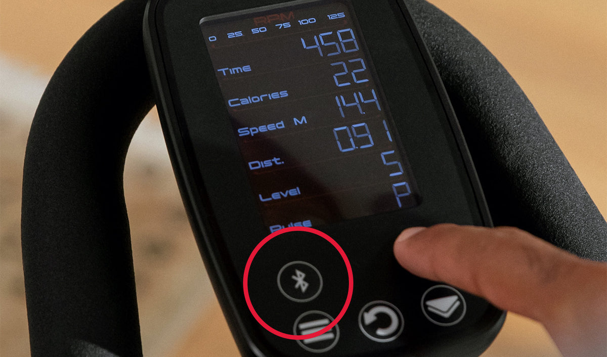 Close up of the BowFlex C6 Bike console with a red circle around the Bluetooth button.