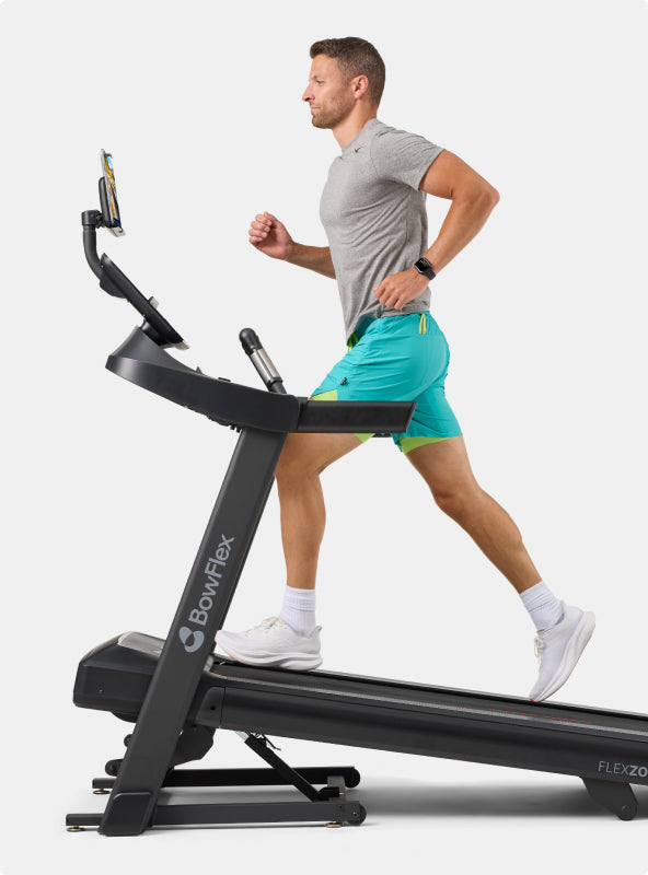 Man running on an inclined BowFlex T6 Treadmill.