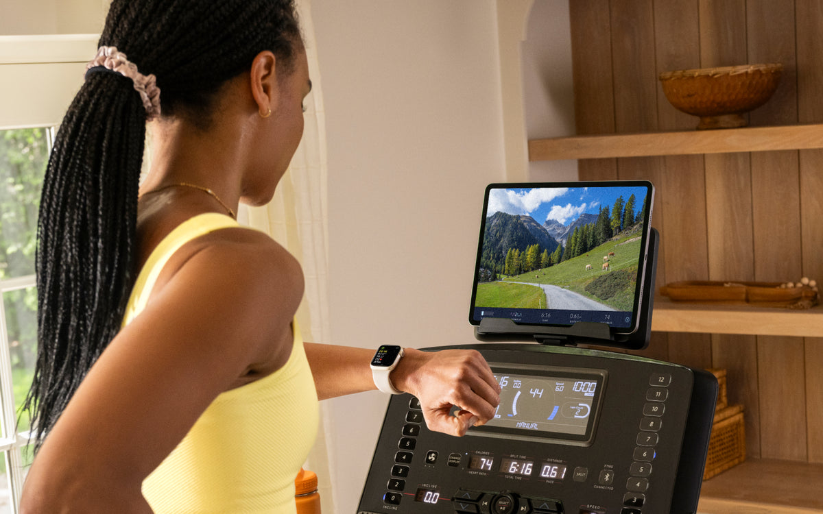 Woman using a BowFlex T9 Treadmill with the JRNY fitness app