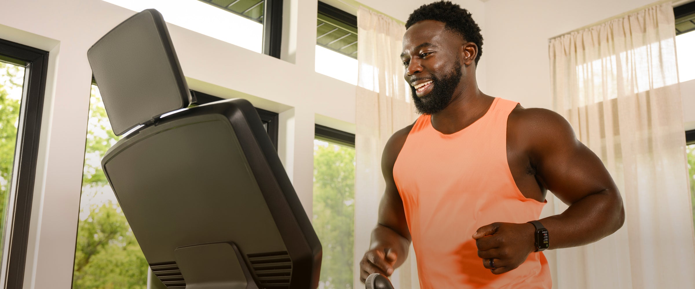 Man running on the BowFlex T16 Treadmill in his house.