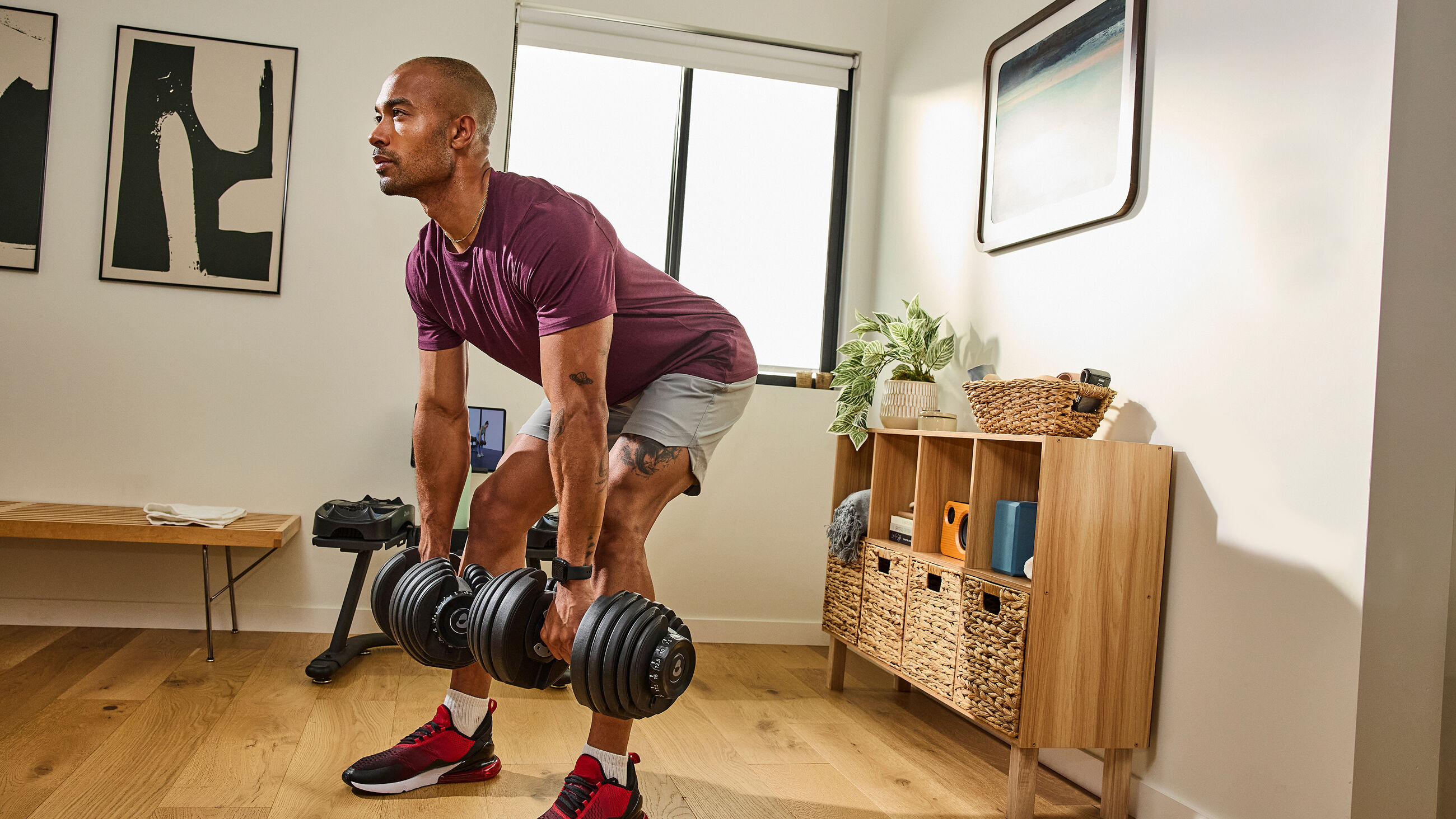 Man exercising with a pair of Results Series 552 dumbbell - default view