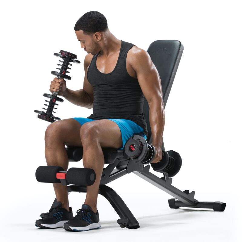 A man using dumbbells on a Bowflex 3.1S Bench. - expanded view