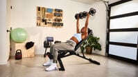 Woman exercising with a pair of Results Series 552 dumbbell--thumbnail