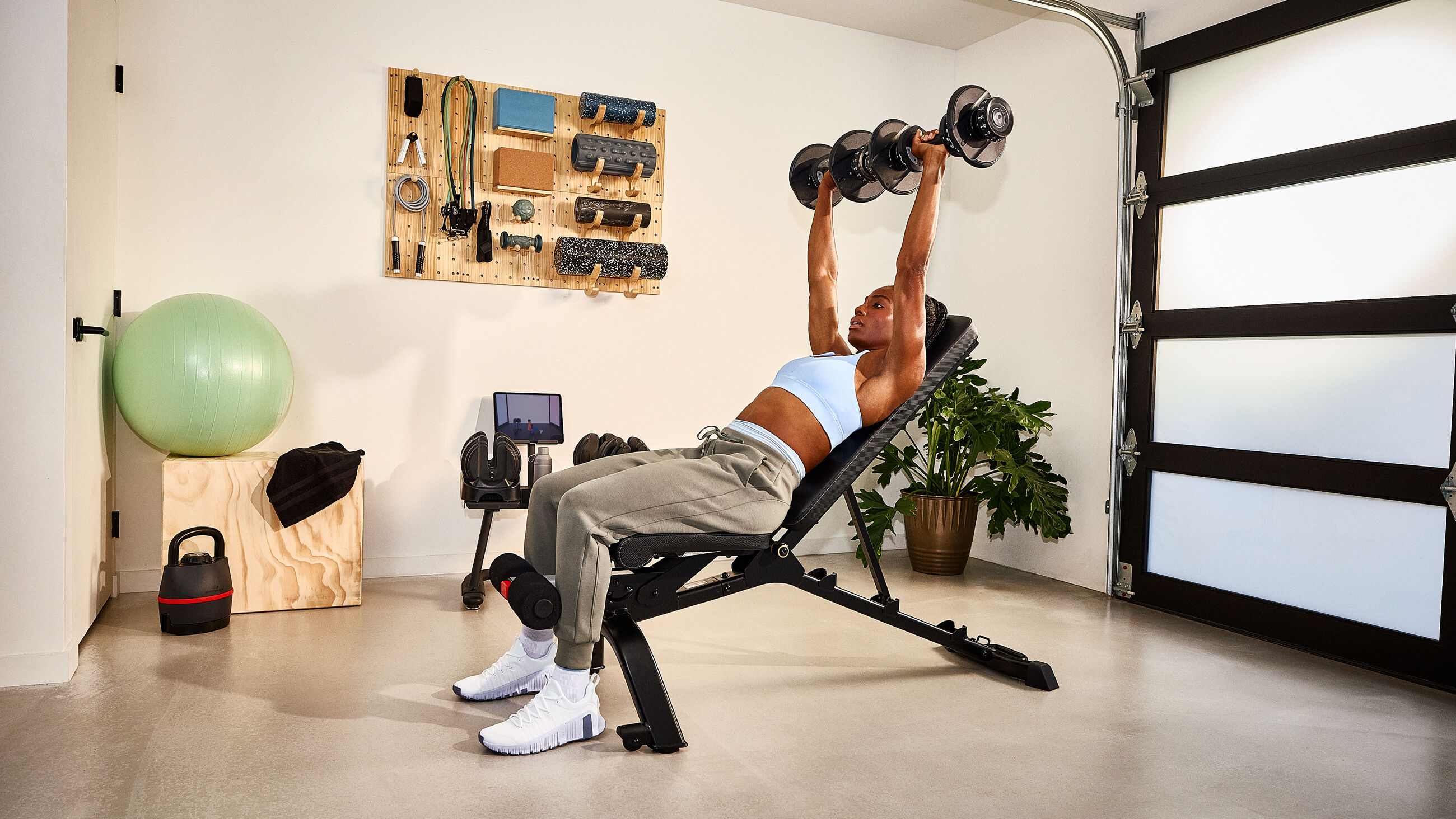 Woman exercising with a pair of Results Series 552 dumbbell - default view