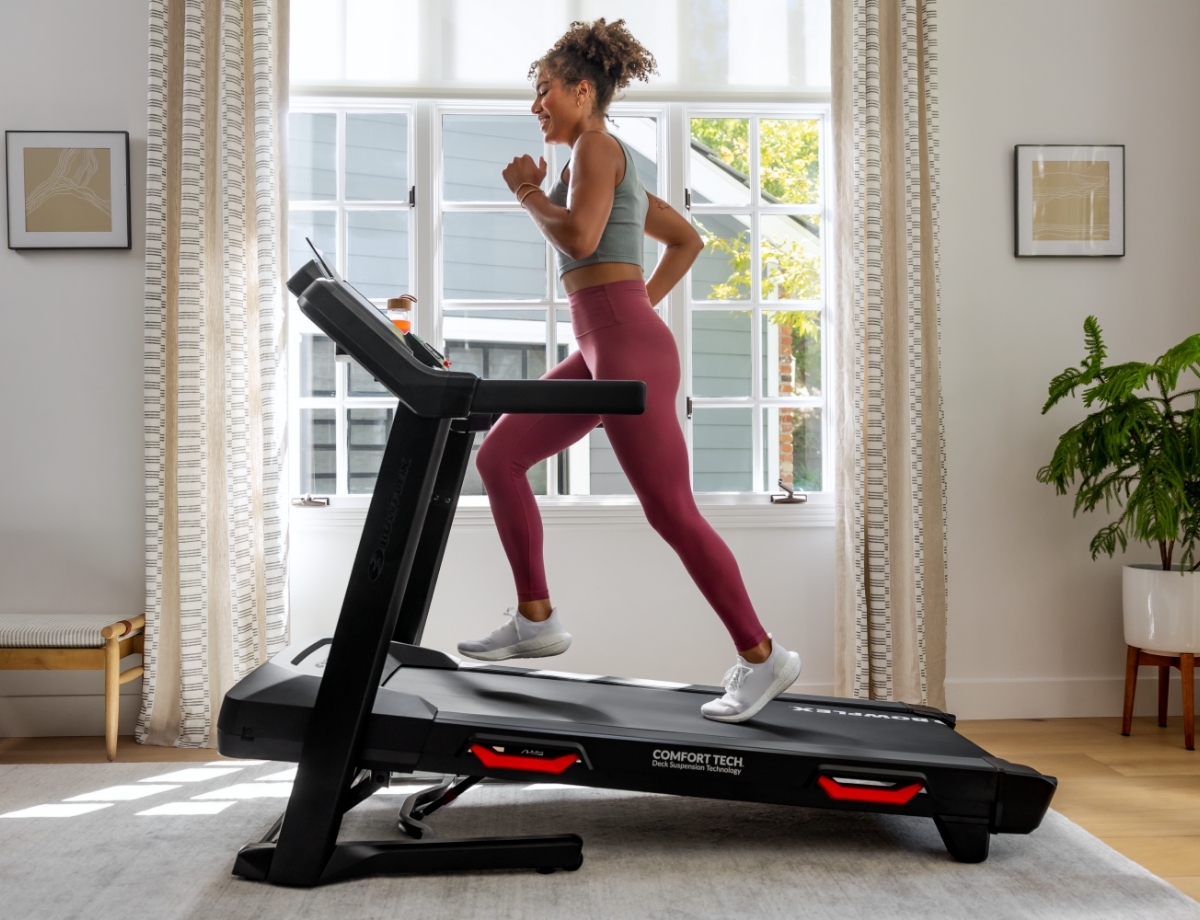 Woman running on BXT8J Treadmill